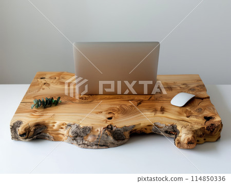 A minimalist style wooden table, featuring an open laptop placed on the surface. A minimalist style wooden table, featuring an open laptop placed on the surface. 114850336