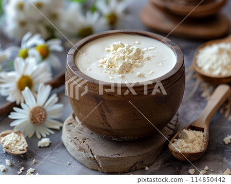 Superfood creamer almond milk, banana and coconut in a mason mug. White background with copy space. Superfood creamer almond milk, banana and coconut in a mason mug. White background with copy space. 114850442