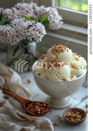 Homemade peanut butter ice cream with peanuts in bowl and flowers 114850453