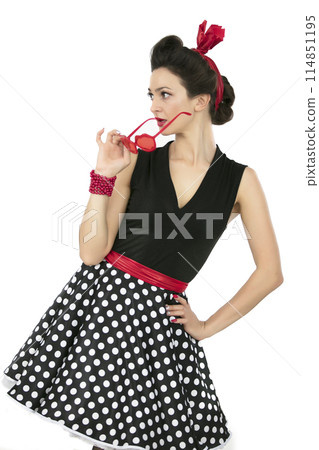 A woman in fifties-style clothes. Beautiful retro girl. A woman in fifties-style clothes. Beautiful retro girl. 114851195