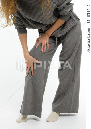 Woman holding hands on knees. Woman holding hands on knees. 114851342