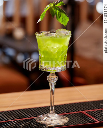 Elegant glass of gin based Basil Smash cocktail on bar Elegant glass of gin based Basil Smash cocktail on bar 114851574