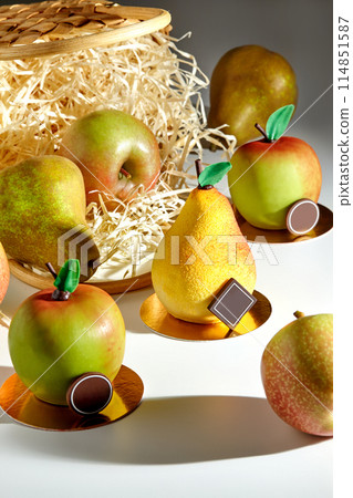 Desserts in shape of pear and apple with fresh fruits and straw basket Desserts in shape of pear and apple with fresh fruits and straw basket 114851587