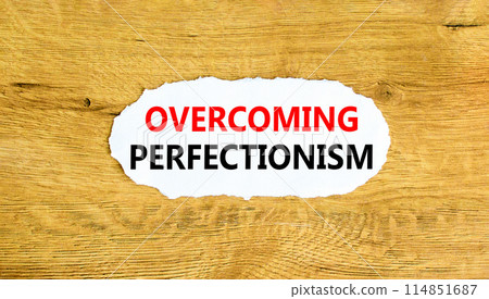 Overcoming perfectionism symbol. Concept words Overcoming perfectionism on beautiful white paper. Beautiful wooden wall background. Business Overcoming perfectionism concept. Copy space. Overcoming perfectionism symbol. Concept words Overcoming perfectionism on beautiful white paper. Beautiful wooden wall background. Business Overcoming perfectionism concept. Copy space. 114851687