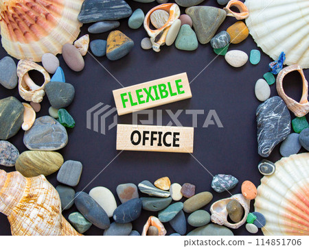 Flexible office symbol. Concept words Flexible office on beautiful wooden block. Sea shell and sea stone. Beautiful black paper background. Business Flexible office concept. Copy space. 114851706