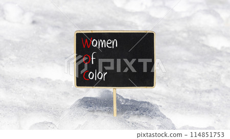 WOC women of color symbol. Concept words WOC women of color on beautiful yellow blackboard. Beautiful white snow background. Business WOC women of color social issues concept. Copy space. 114851753