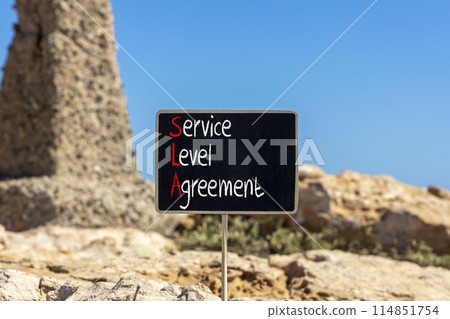 SLA service level agreement symbol. Concept words SLA service level agreement on beautiful yellow blackboard. Beautiful stone background. Business SLA service level agreement concept. Copy space. 114851754