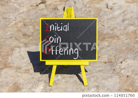 ICO initial coin offering symbol. Concept words ICO initial coin offering on beautiful yellow blackboard. Beautiful stone background. Business ICO initial coin offering concept. Copy space. 114851760