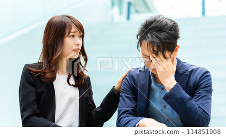 A businesswoman encouraging a depressed colleague/subordinate A businesswoman encouraging a depressed colleague/subordinate 114851908