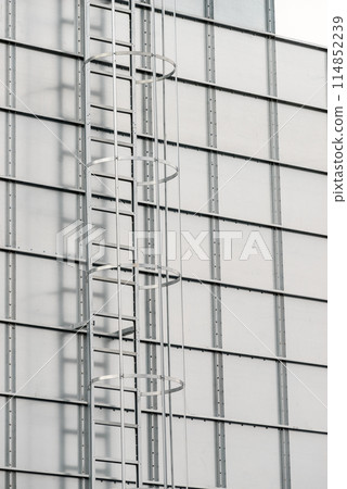 Industrial metal ladder with round railing Industrial metal ladder with round railing 114852239