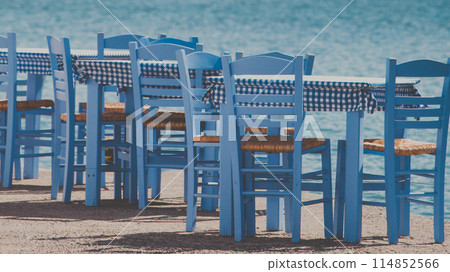 Open cafe outdoor restaurant in Greece on sea shore 114852566
