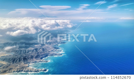 Aerial view of the sea and mountains from a plane window. 114852670
