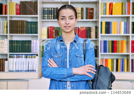 Portrait of smiling teenage girl student, inside high school building 114853089