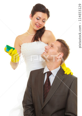 Bride and groom sharing household duties 114853129