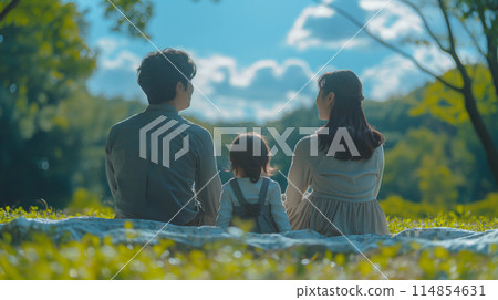 The backs of a family sitting in the park The backs of a family sitting in the park 114854631