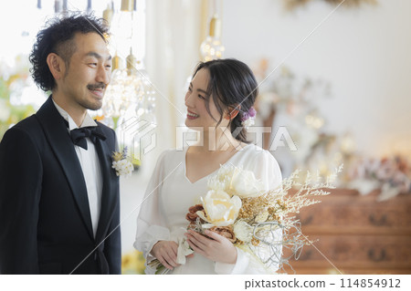 Bride and groom in dress and tuxedo 114854912