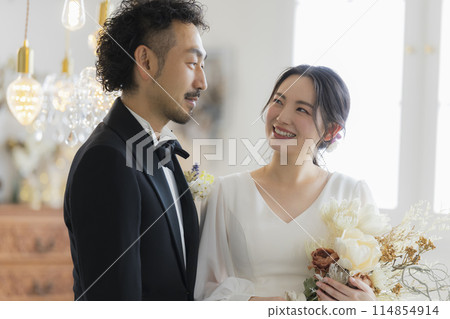 Bride and groom in dress and tuxedo 114854914