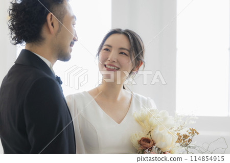 Bride and groom in dress and tuxedo Bride and groom in dress and tuxedo 114854915