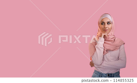 Curious woman. Advertising background. Pensive interested girl in hijab thinking considering offer isolated on pink empty space. Curious woman. Advertising background. Pensive interested girl in hijab thinking considering offer isolated on pink empty space. 114855325