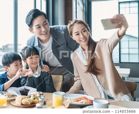 Family taking a selfie at a restaurant 114855666