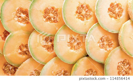 Image of sliced red-fleshed melon arranged in a regular pattern 114856414
