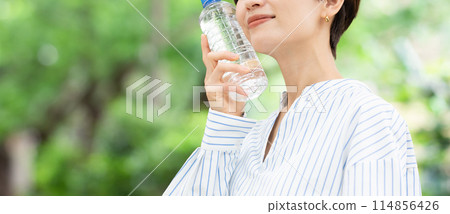 A woman drinking water 114856426