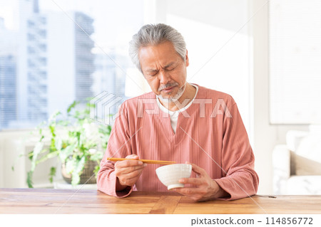 Senior man eating, loss of appetite 114856772