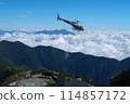 A helicopter transporting luggage to a mountain hut 114857172