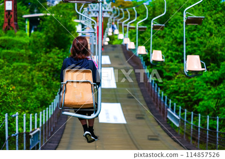 Woman riding on a ropeway Woman riding on a ropeway 114857526