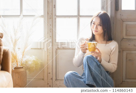 一個女人在一個房間裡喝咖啡 114860143