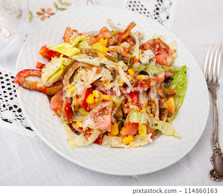 On plate, portion is laid out with pim salad of corn, cabbage, mayonnaise. On plate, portion is laid out with pim salad of corn, cabbage, mayonnaise. 114860163