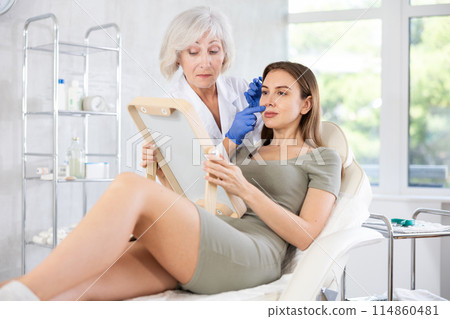 Young patient with mirror Young patient with mirror 114860481