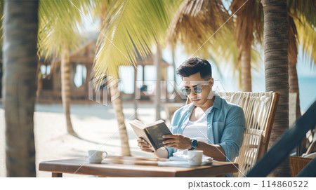 man reading books in tropical beach 114860522