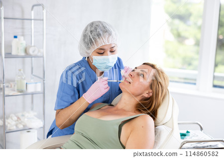 Blonde european women getting facial beauty treatment 114860582