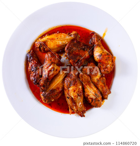 Plate of tasty snack - roasted chicken wings closeup 114860720