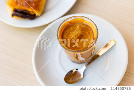 Cup of cortado, Spanish beverage made of espresso with dessert Cup of cortado, Spanish beverage made of espresso with dessert 114860726