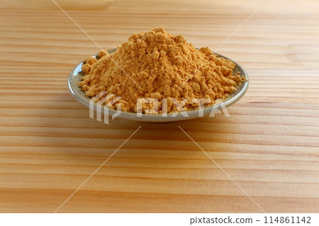 Kinako (roasted soybean flour) served in a small dish on a table background 114861142