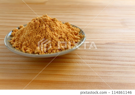 Kinako (roasted soybean flour) served in a small dish on a table background 114861146