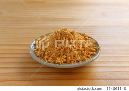 Kinako (roasted soybean flour) served in a small dish on a table background 114861148