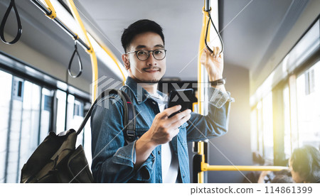 Man traveling by bus, operating smartphone Man traveling by bus, operating smartphone 114861399