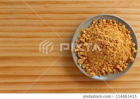 Kinako (roasted soybean flour) served in a small dish on a table background 114861415