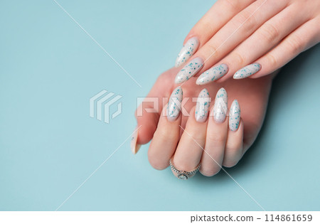 Female hands with blue nail design. Blue nail polish manicure. 114861659