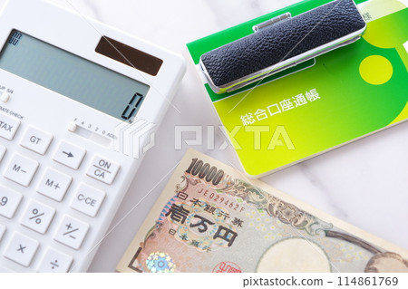 A bank passbook, a personal seal, a 10,000 yen note, and a calculator on a table A bank passbook, a personal seal, a 10,000 yen note, and a calculator on a table 114861769