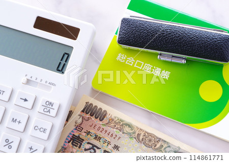 A bank passbook, a personal seal, a 10,000 yen note, and a calculator on a table A bank passbook, a personal seal, a 10,000 yen note, and a calculator on a table 114861771
