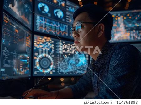 A scientist in a laboratory analyzes data on multiple screens while concentrating on graphs. 114861888