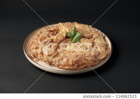 Thai style pork omelette in ceramic plate on black background. 114862523