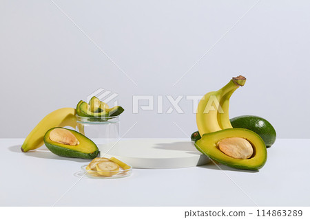 Template to design advertising images for health care or beauty products derived from natural fruits such as avocado and banana, a blank platform in white color for presentation, copy space 114863289