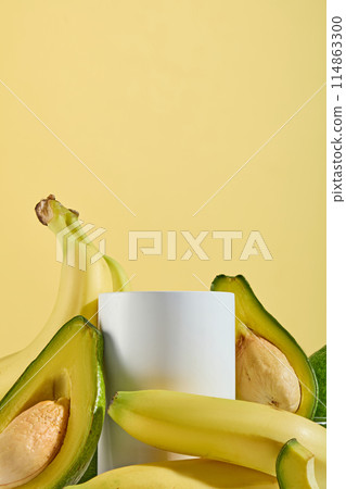 Frontal shot template photo for designing advertising of products made from natural fruit ingredients such as banana and avocado, which has many benefit for health and beauty, blank podium in center Frontal shot template photo for designing advertising of products made from natural fruit ingredients such as banana and avocado, which has many benefit for health and beauty, blank podium in center 114863300