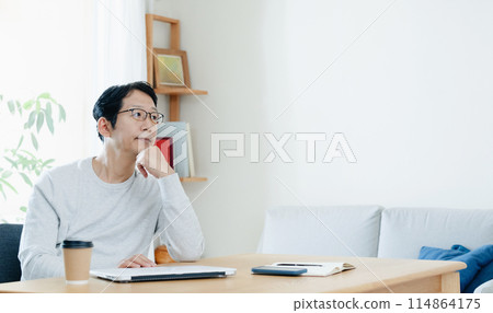 A man who is tired from teleworking 114864175