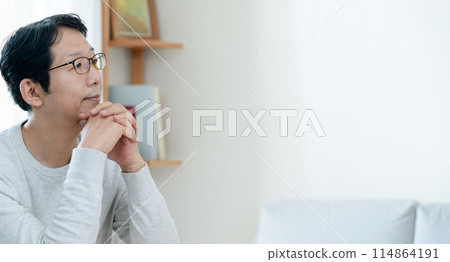 A man who is tired from teleworking A man who is tired from teleworking 114864191